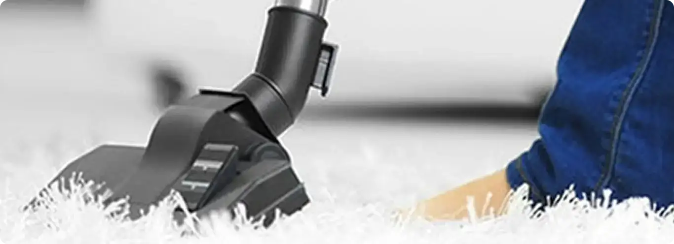 Close-up of a professional vacuuming a white carpet in Federal Way.